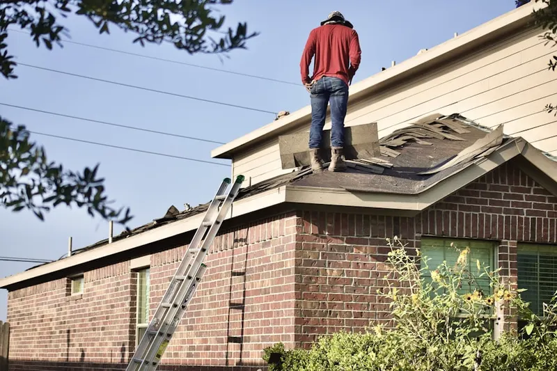 Professional roofer working on a residential roof in Albemarle
